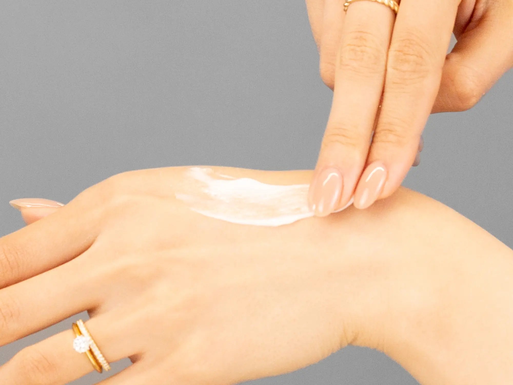 Laziza from LAZ Skincare demonstrating the texture and application of Hale & Hush HydroMelon Cream on her hand
