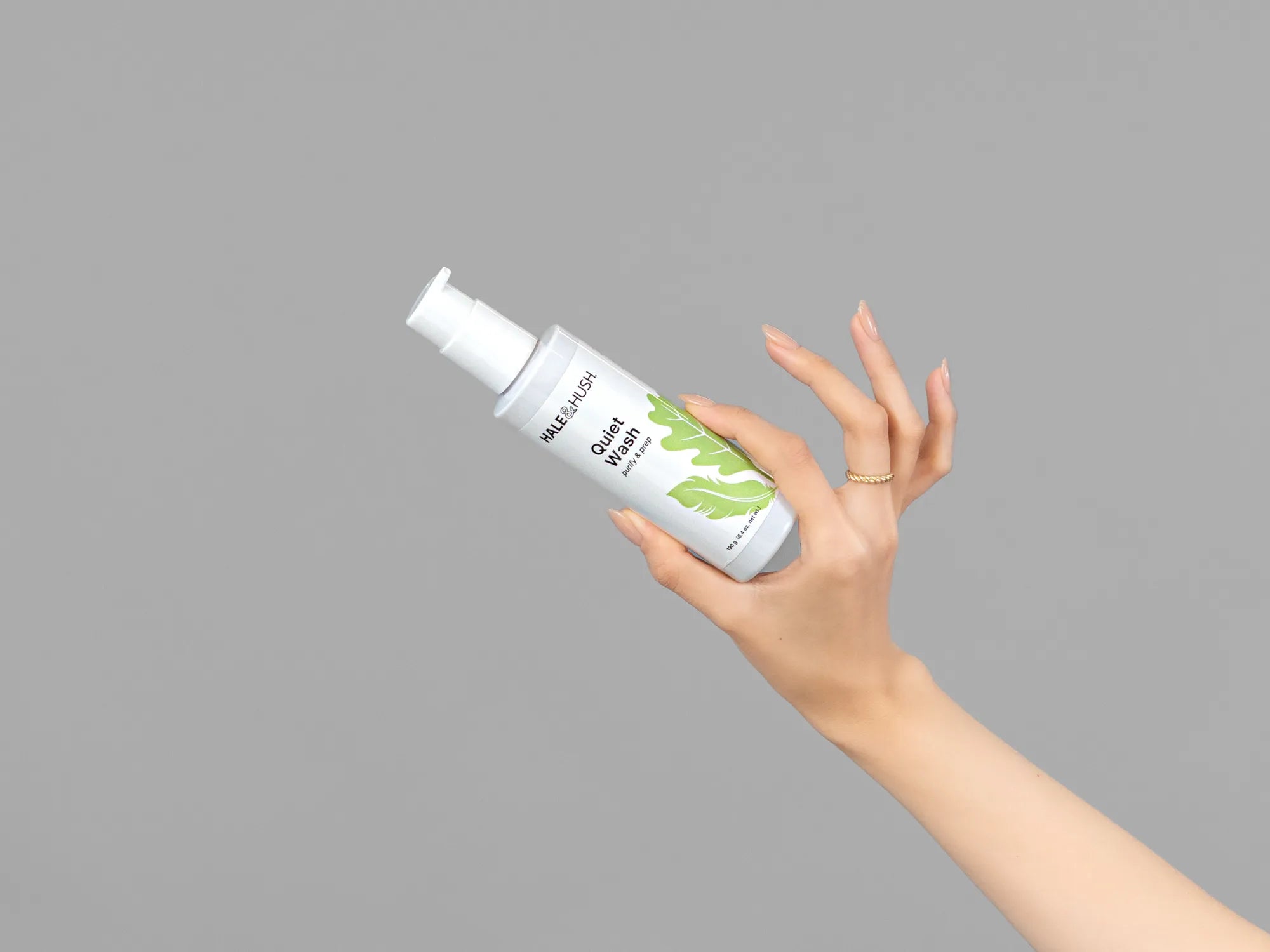 Closeup of Laziza from LAZ Skincare holding up a bottle of Hale & Hush Quiet Wash