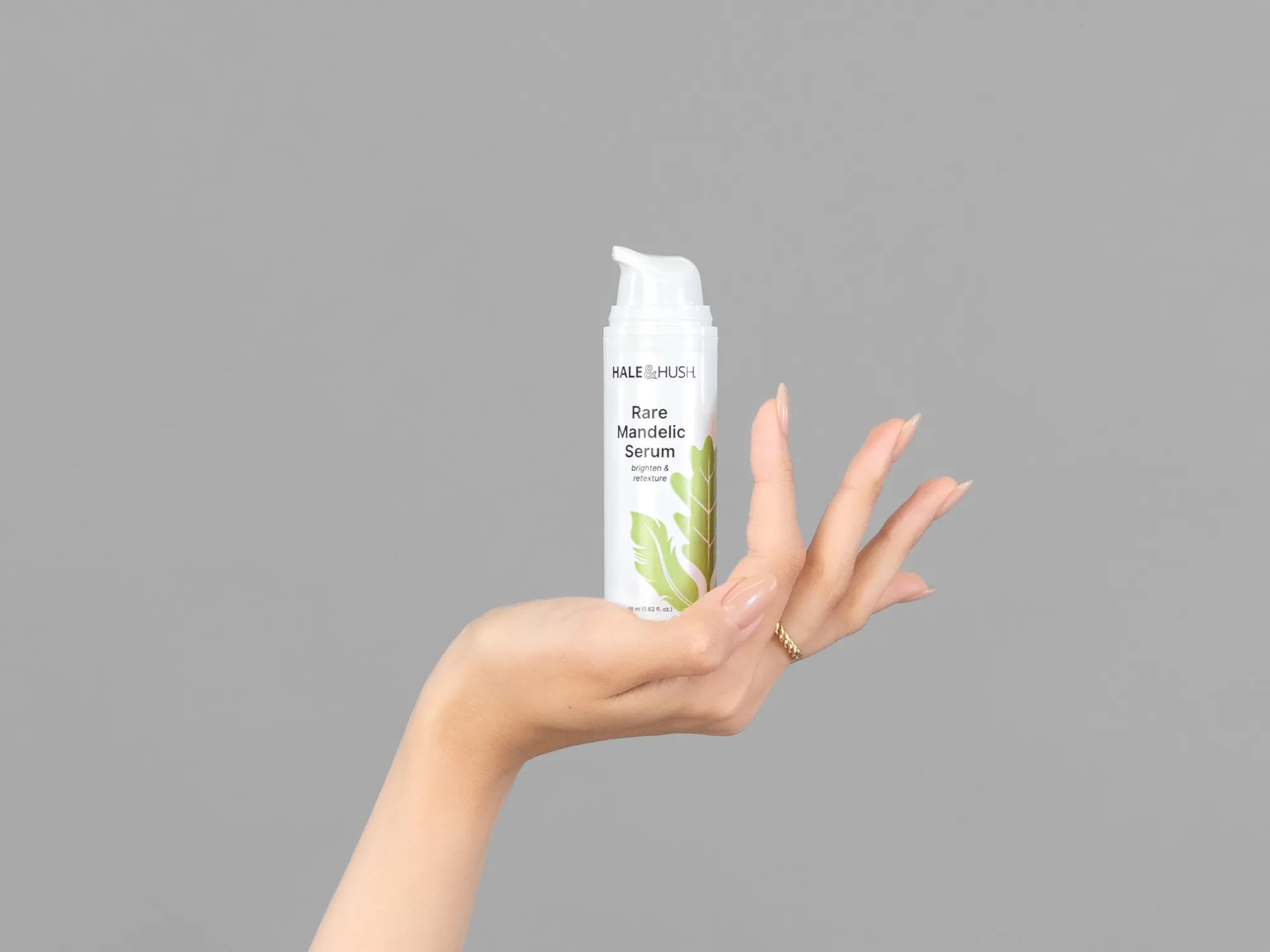 Closeup of Laziza from LAZ Skincare holding up a bottle of Hale & Hush Rare Mandelic Serum