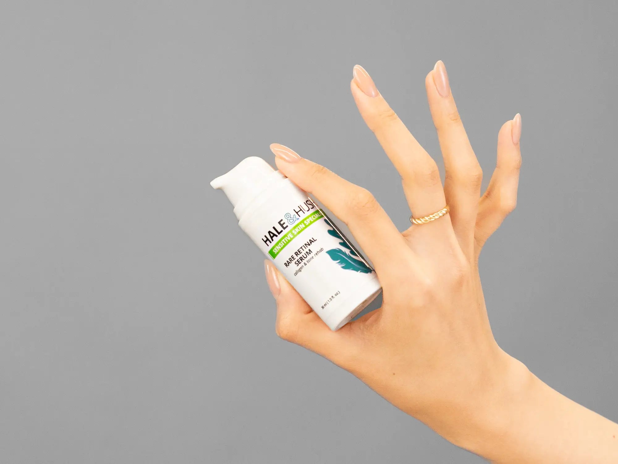 Closeup of Laziza from LAZ Skincare holding up a bottle of Hale & Hush Rare Retinal Serum