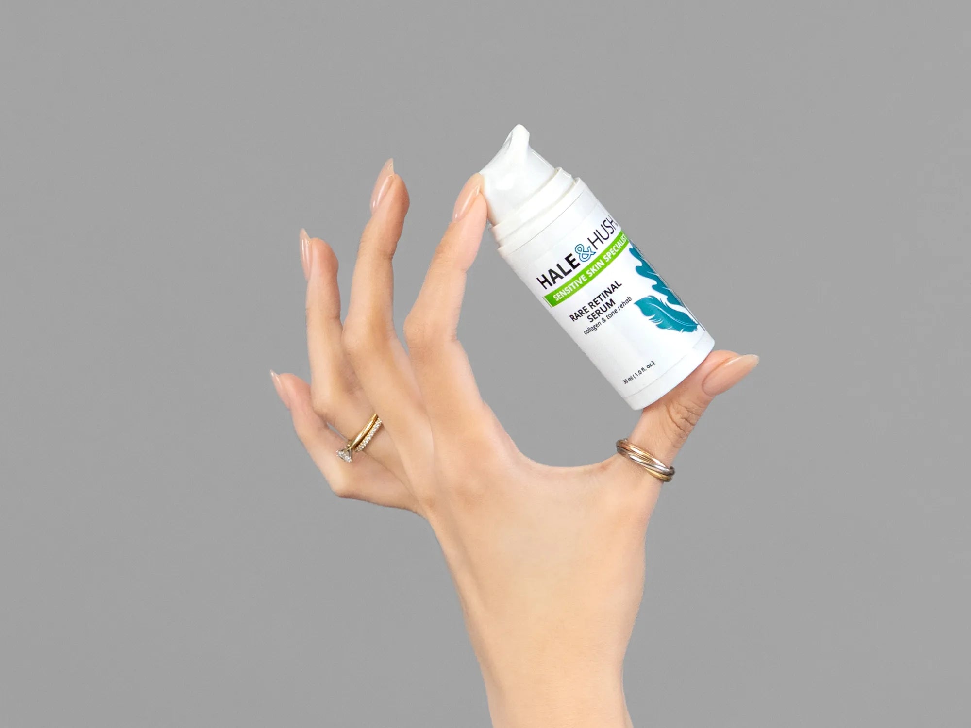 Closeup of Laziza from LAZ Skincare holding up a bottle of Hale & Hush Rare Retinal Serum