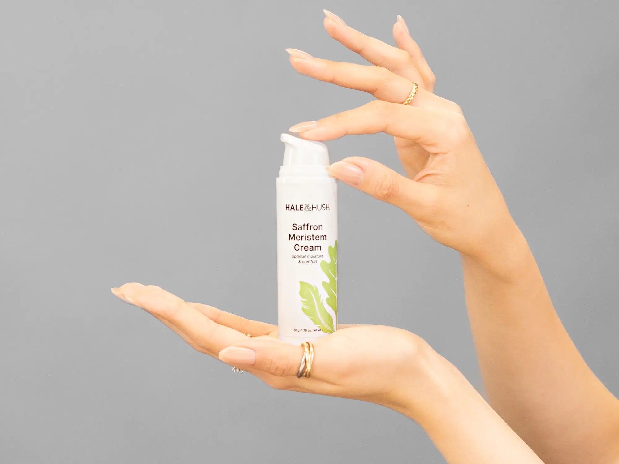 Closeup of Laziza from LAZ Skincare holding up a bottle of Hale & Hush Saffron Meristem Cream