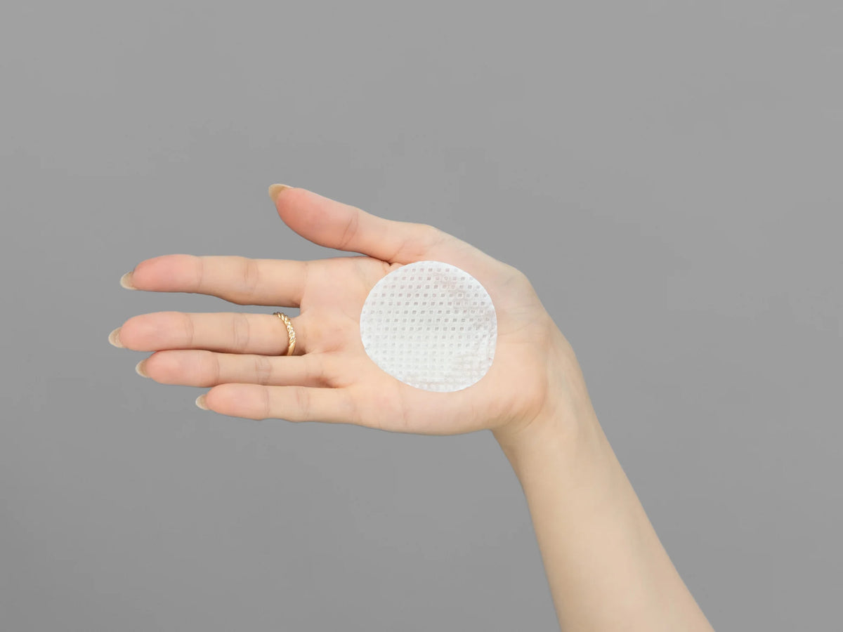 Laziza from LAZ Skincare demonstrating the texture and application of Hydrinity RetaXome Retinal Boost Treatment Pads on her hand