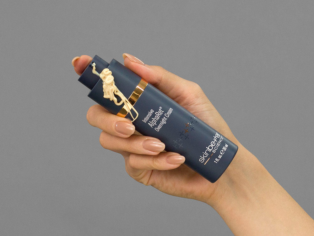 Laziza from LAZ Skincare demonstrating the texture and application of SkinBetter Science Intensive AlphaRet Overnight Cream on her hand