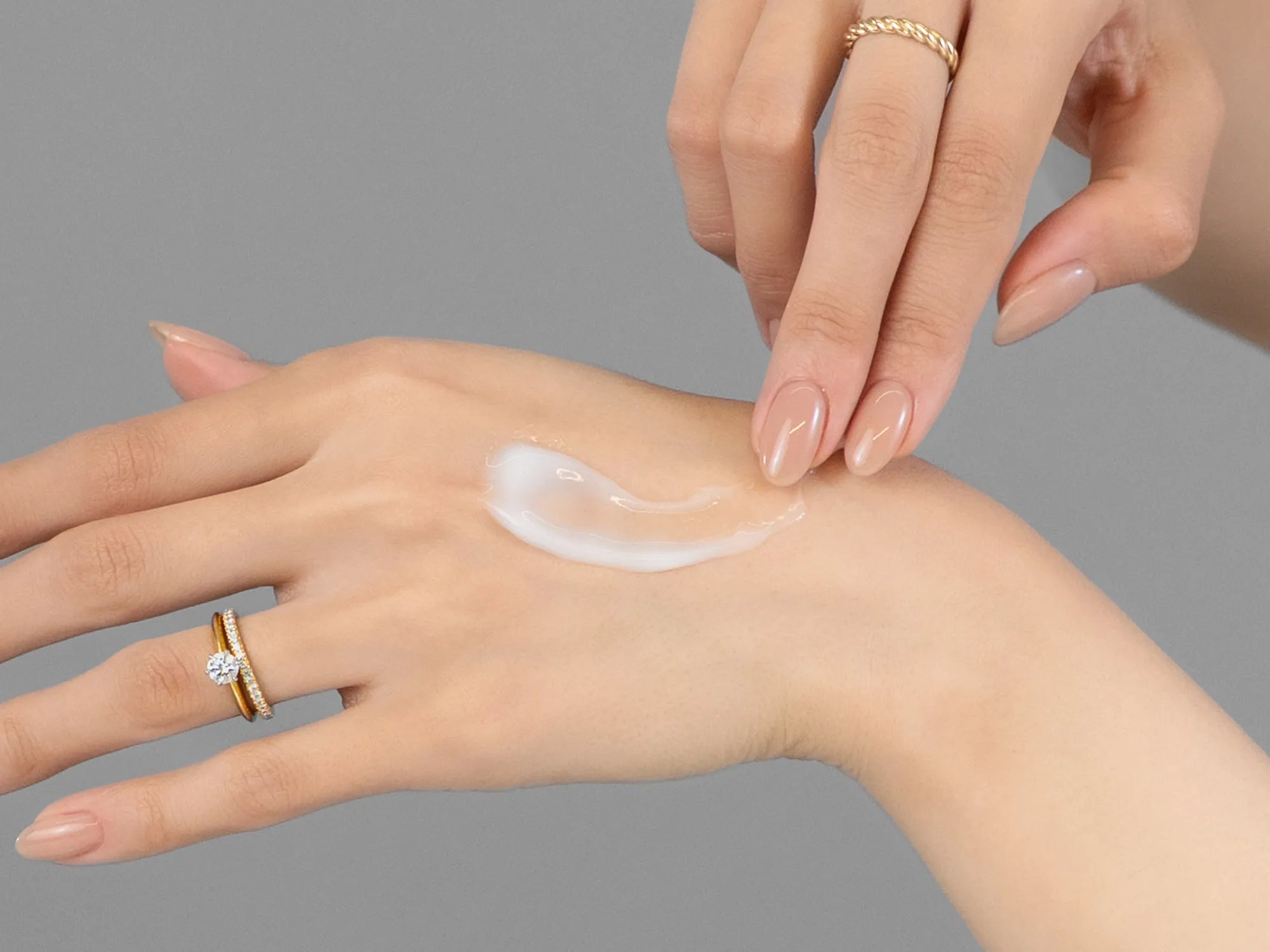 Laziza from LAZ Skincare demonstrating the texture and application of KrX Aesthetics Active 31 Revitalizing Eye Cream on her hand