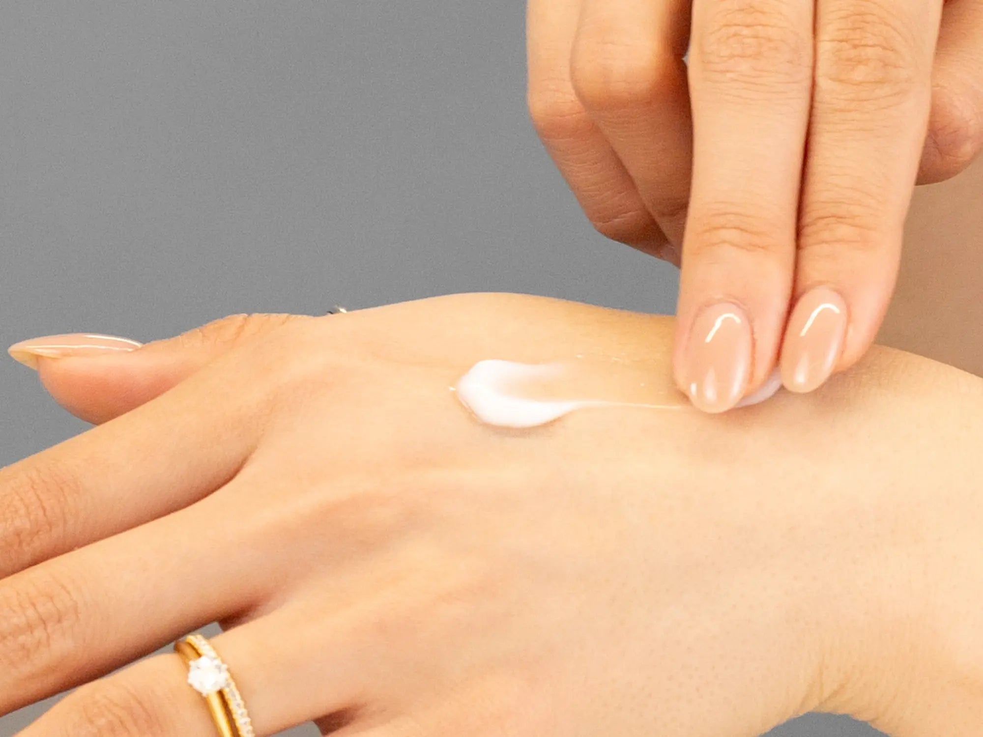 Laziza from LAZ Skincare demonstrating the texture and application of KrX Aesthetics Active 31 Revitalizing Eye Cream on her hand