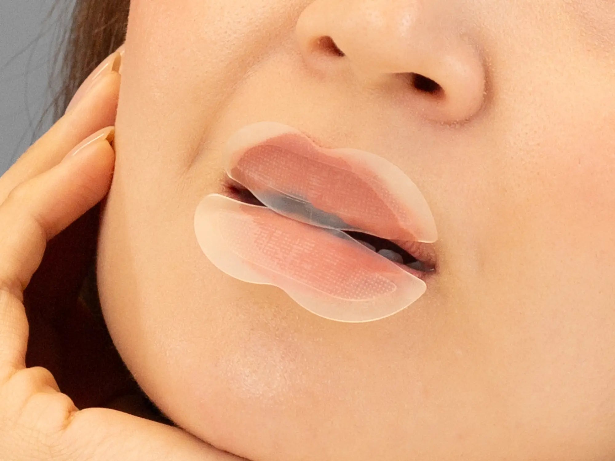 Laziza from LAZ Skincare demonstrating the texture and application of KrX Aesthetics Lip Darts on her hand