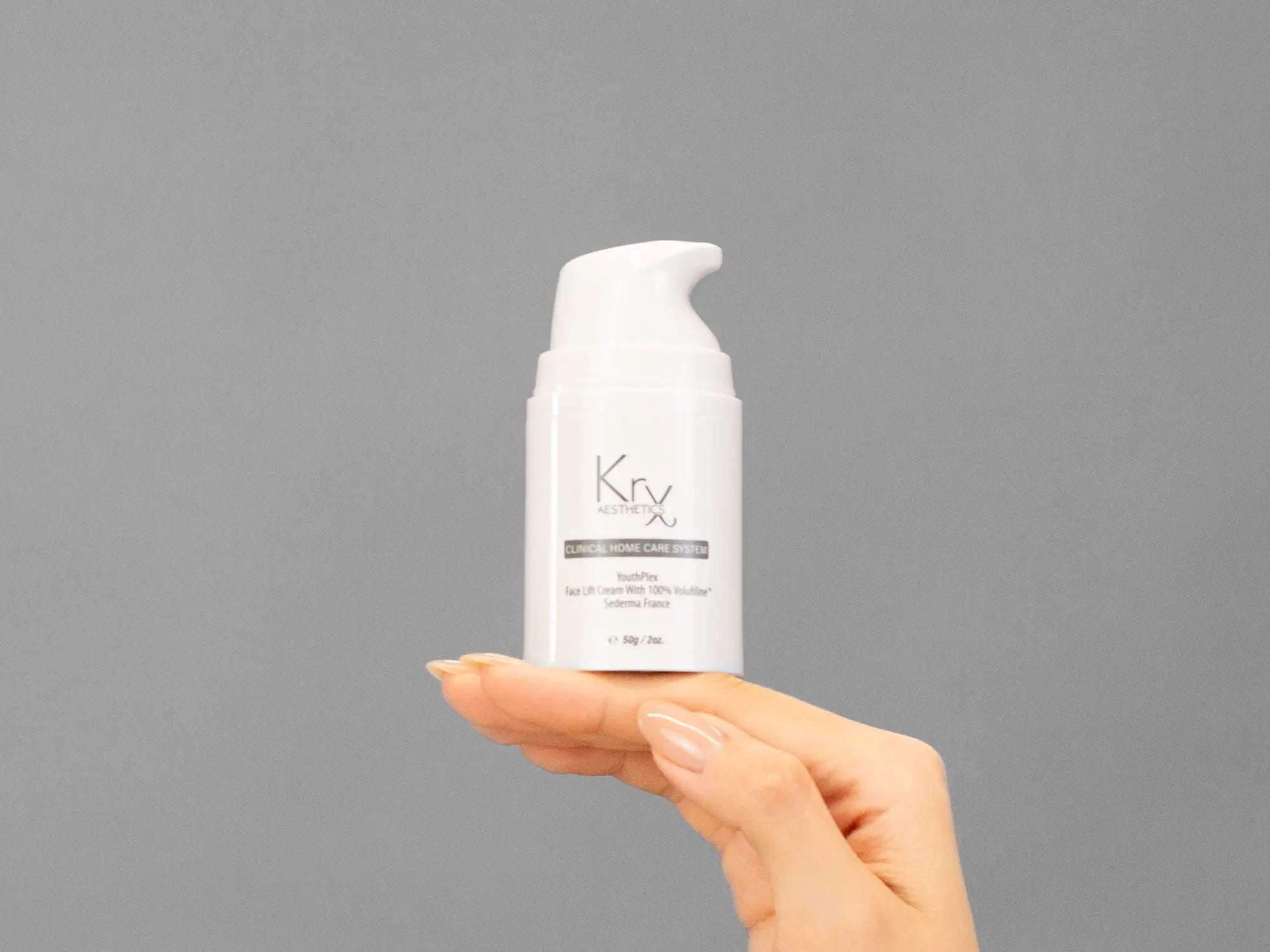 Closeup of Laziza from LAZ Skincare holding up a bottle of KrX Aesthetics Youthplex Face Lift Cream