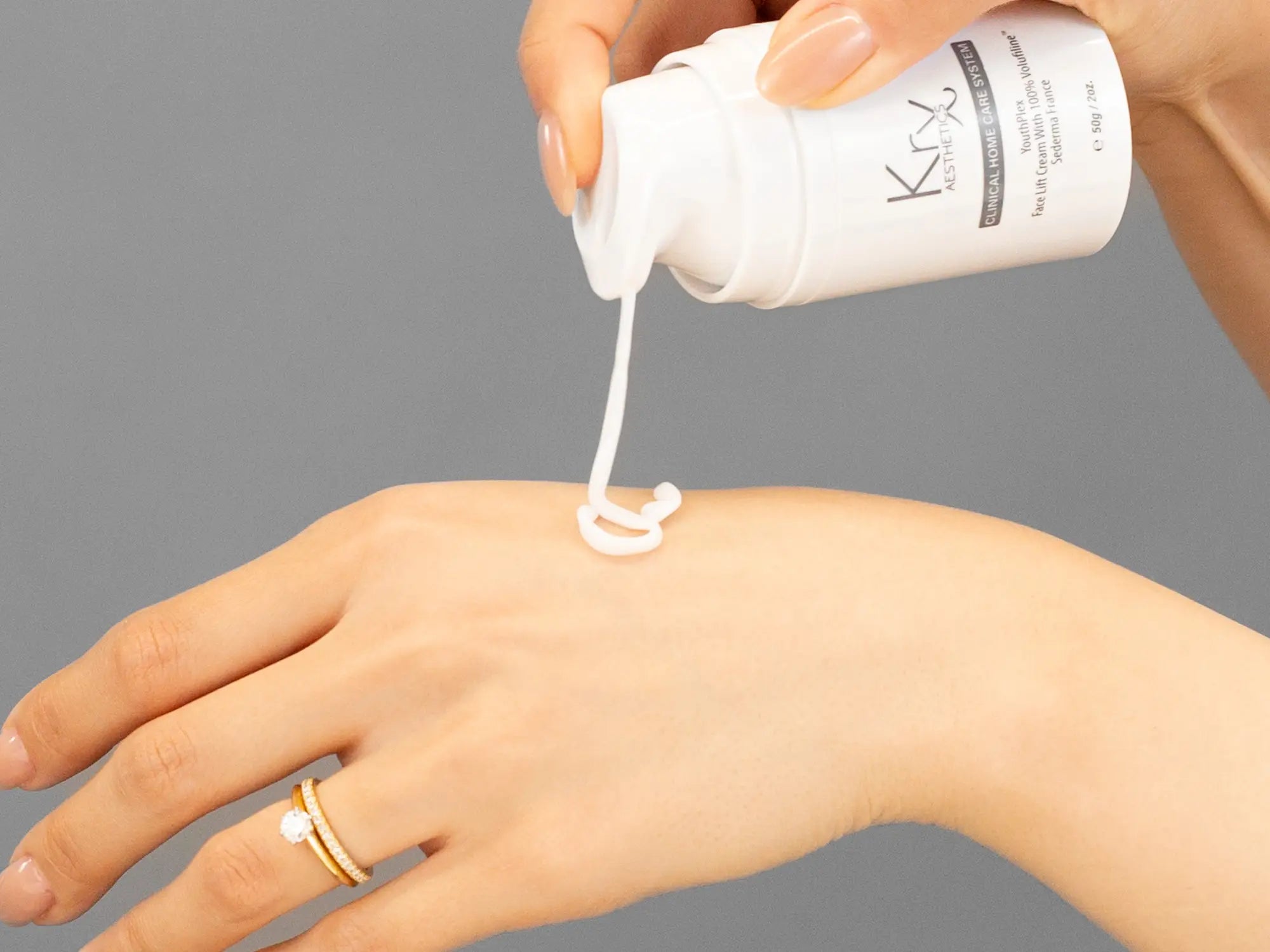 Laziza from LAZ Skincare demonstrating the texture and application of KrX Aesthetics Youthplex Face Lift Cream on her hand