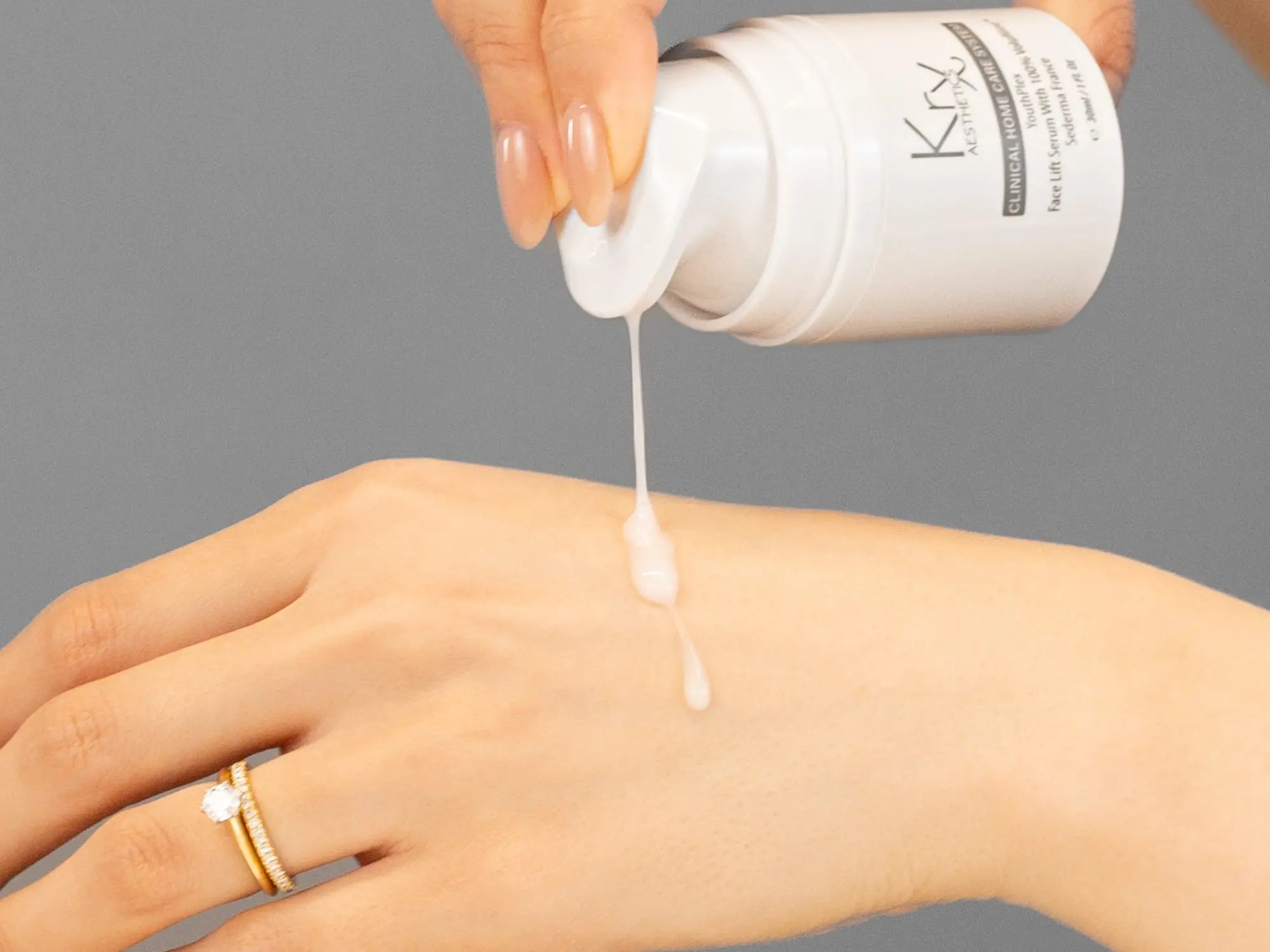 Laziza from LAZ Skincare demonstrating the texture and application of KrX Aesthetics Youthplex Face Lift Serum on her hand