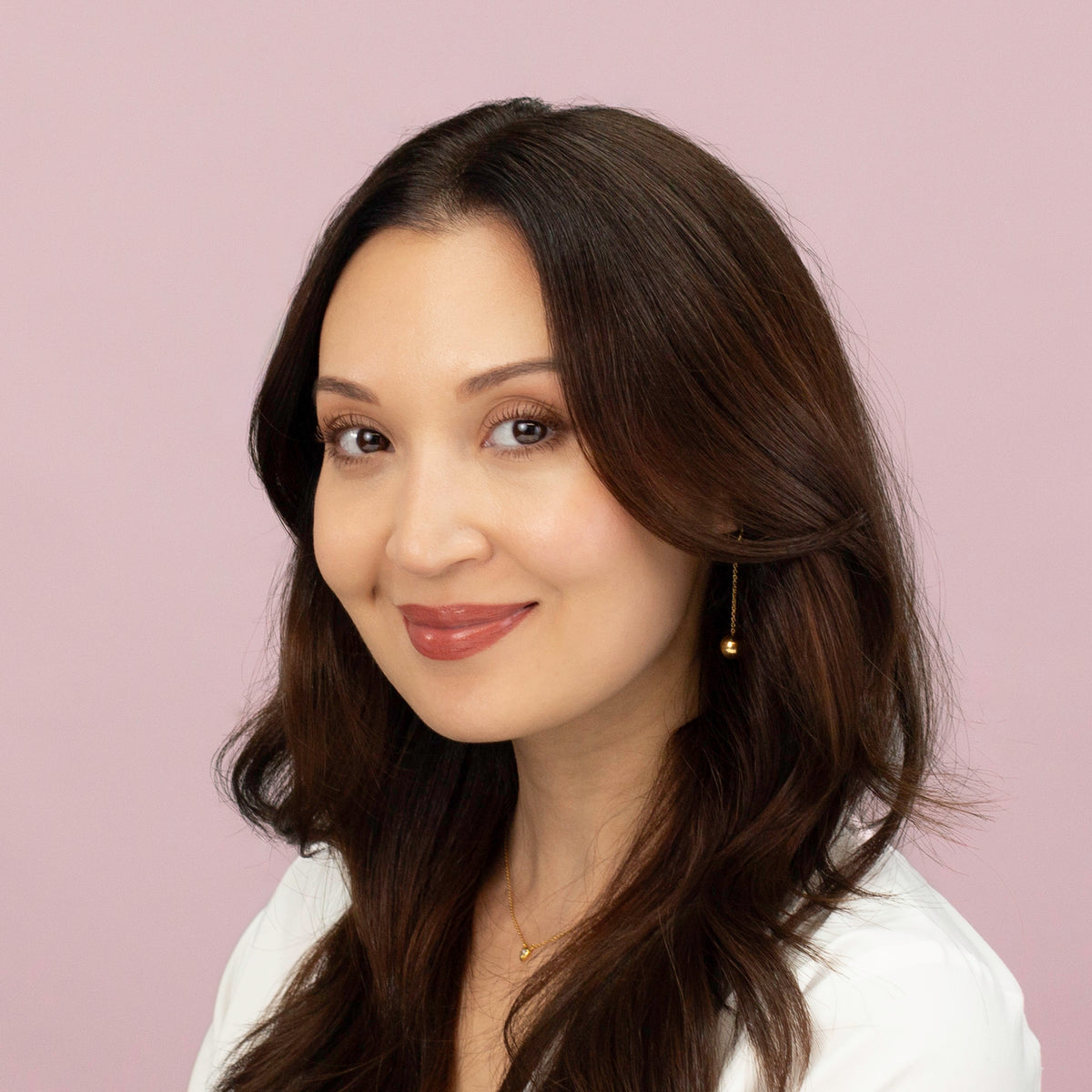 Laziza Strait, licensed esthetician and founder of LAZ Skincare, in a lab coat