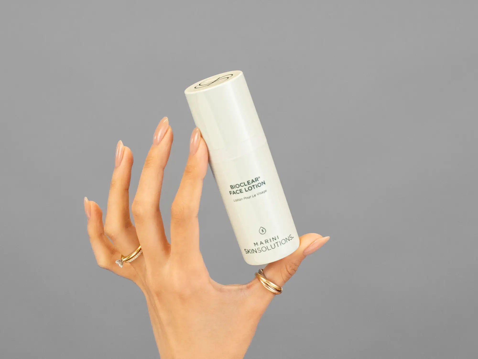 Closeup of Laziza from LAZ Skincare holding up a bottle of Marini SkinSolutions Bioclear Face Lotion
