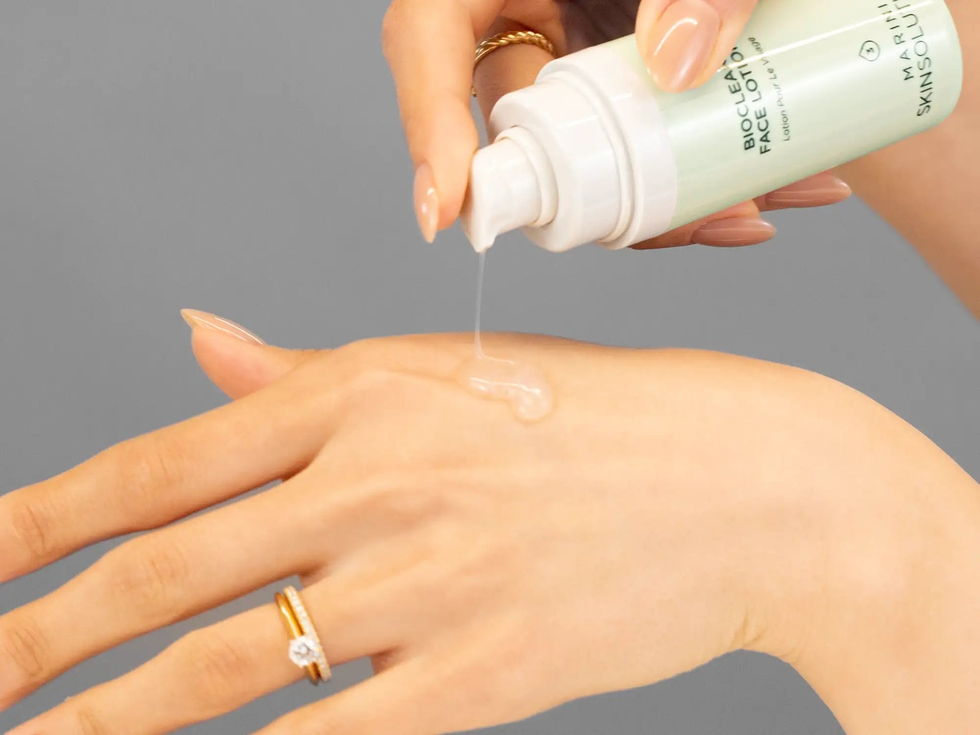 Laziza from LAZ Skincare demonstrating the texture and application of Marini SkinSolutions Bioclear Face Lotion on her hand