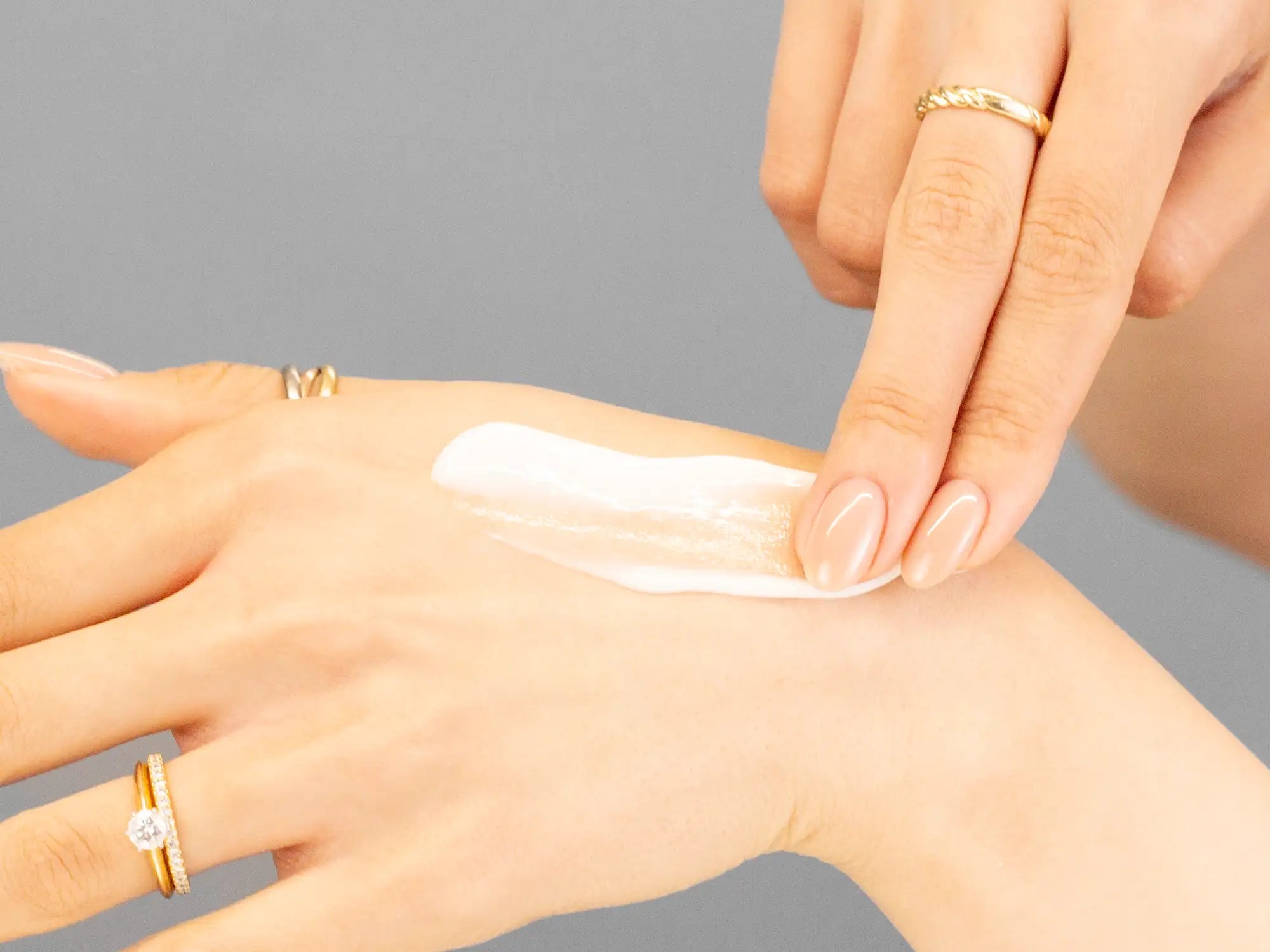 Laziza from LAZ Skincare demonstrating the texture and application of Marini SkinSolutions CelluliTx on her hand