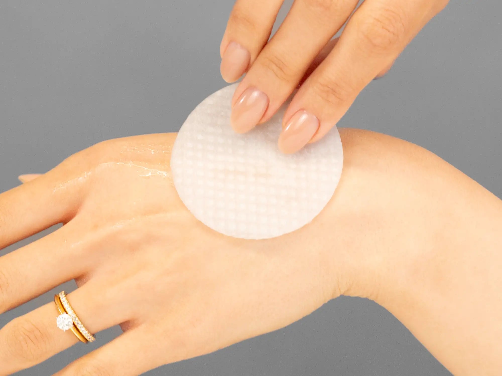 Laziza from LAZ Skincare demonstrating the texture and application of Marini SkinSolutions Marini Clear Corrective Pads on her hand