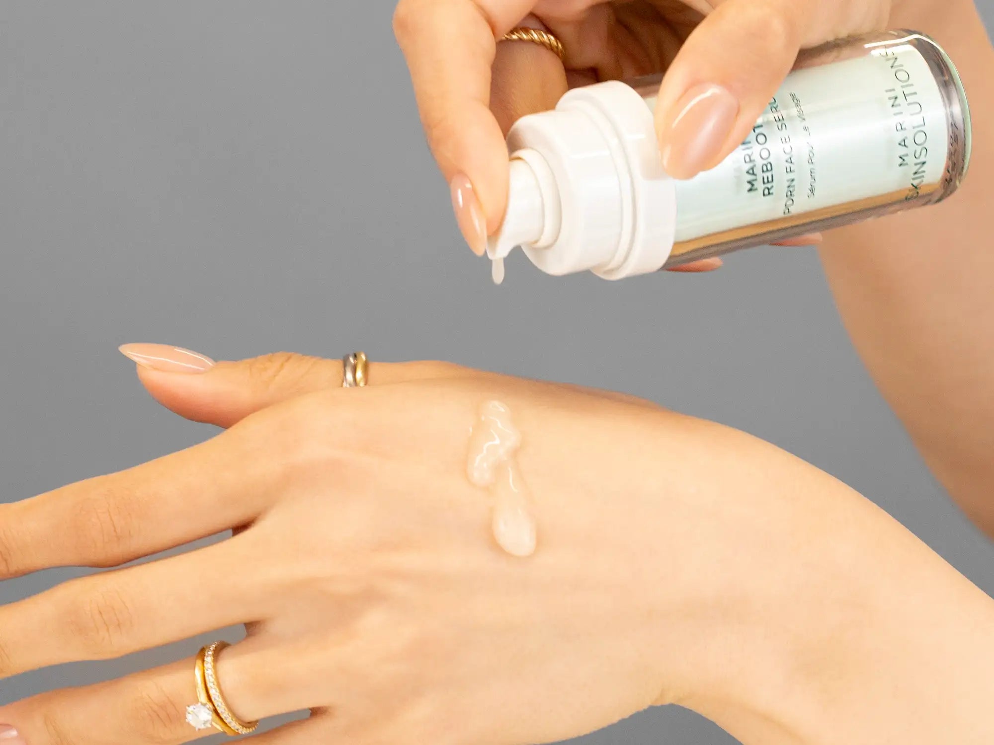 Laziza from LAZ Skincare demonstrating the texture and application of Marini SkinSolutions Marini Reboot PDRN Face Serum on her hand