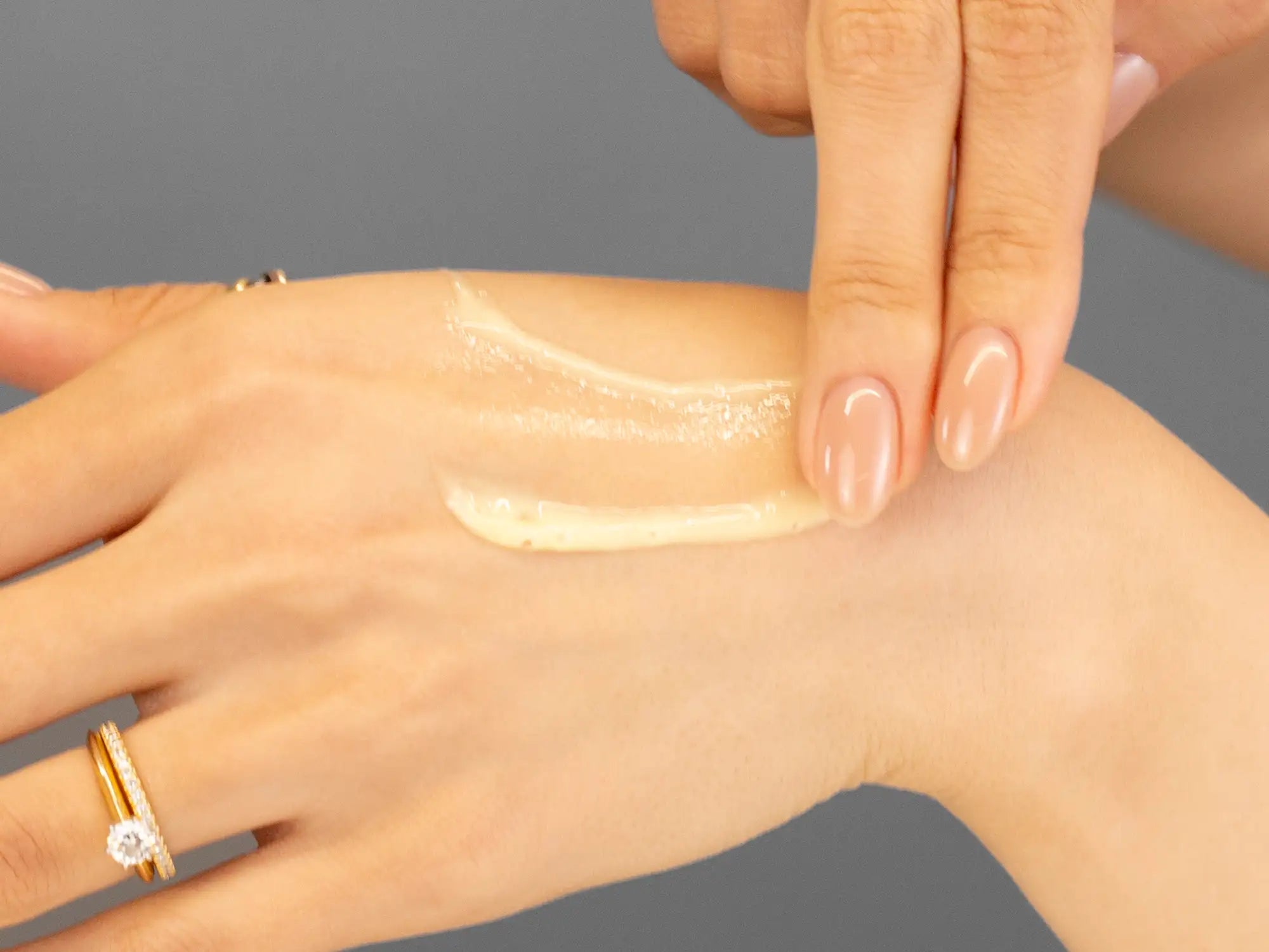 Laziza from LAZ Skincare demonstrating the texture and application of Marini SkinSolutions Regeneration Booster on her hand
