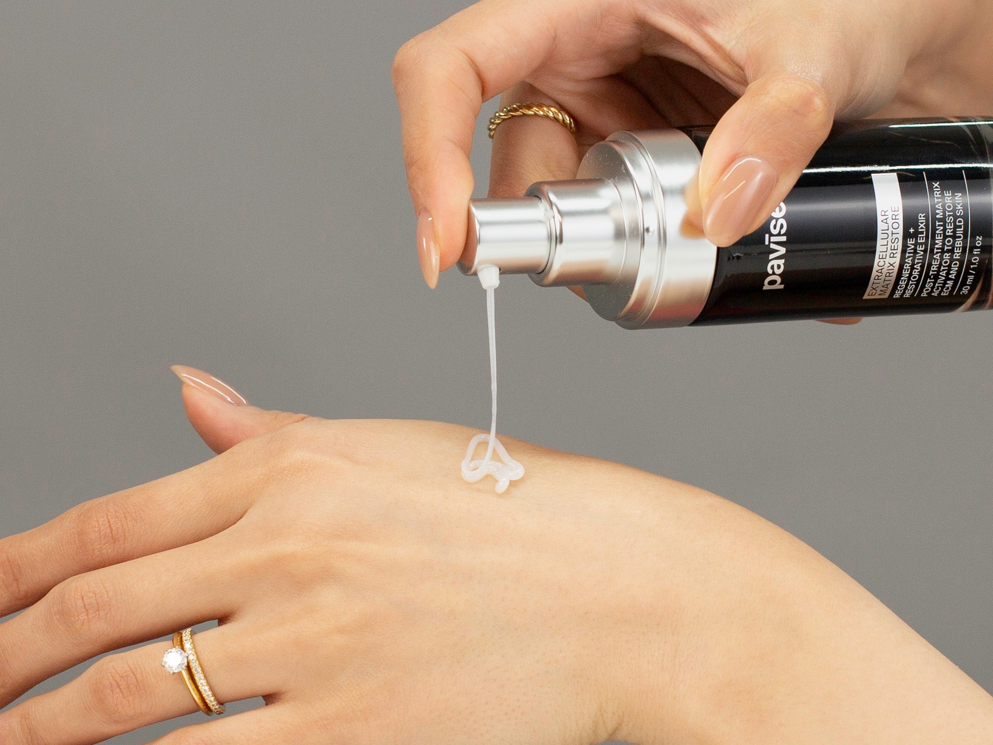 Closeup of Laziza from LAZ Skincare applying Pavise Extracellular Matrix Restore to her hand