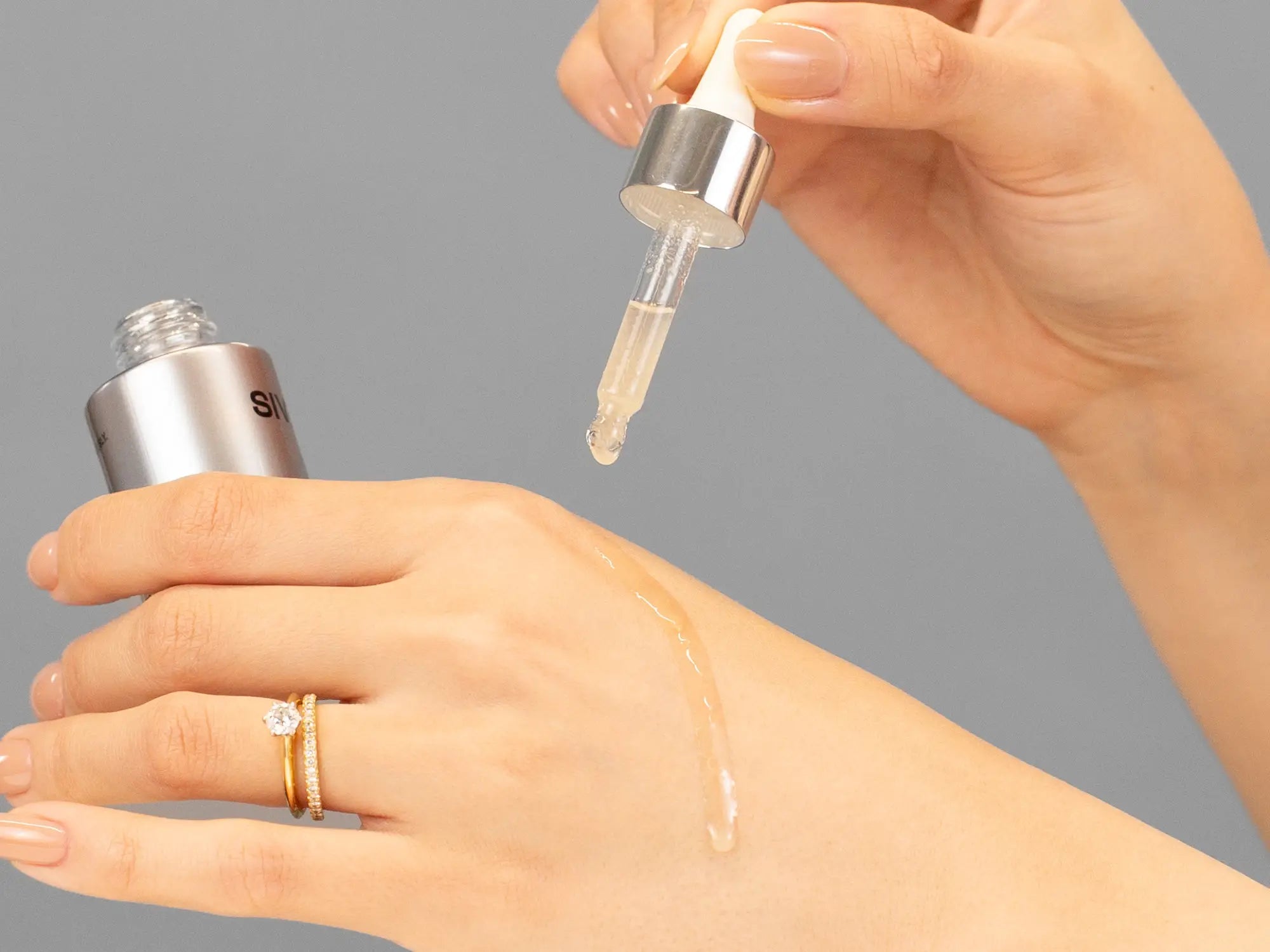 Laziza from LAZ Skincare demonstrating the texture and application of SIV Biome Balancing Serum on her hand