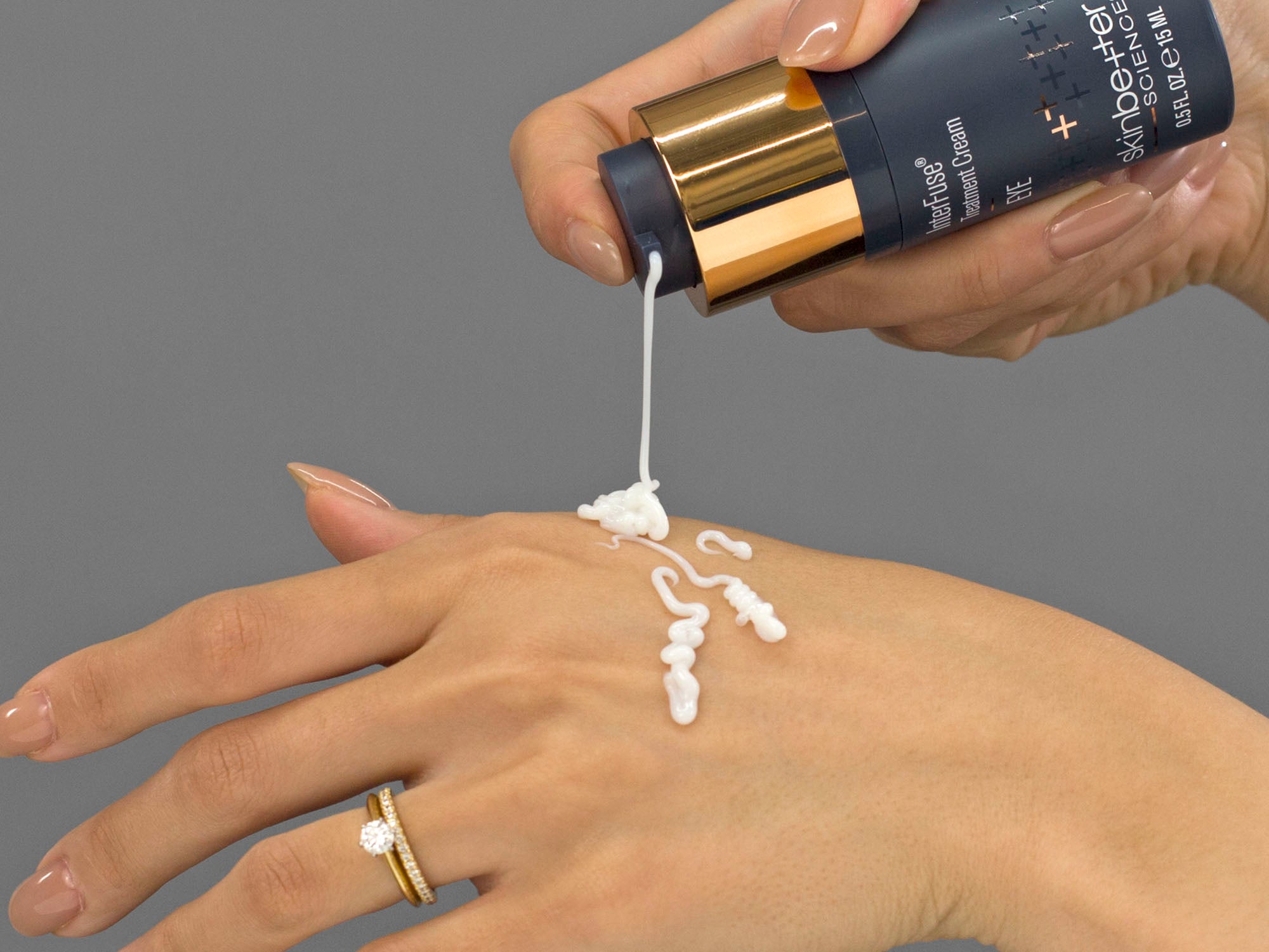 Laziza from LAZ Skincare demonstrating the texture and application of SkinBetter Science InterFuse Treatment Cream EYE on her hand