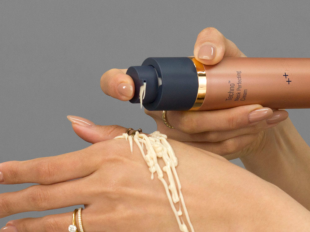 Laziza from LAZ Skincare demonstrating the texture and application of SkinBetter Science Techno Neck Perfecting Cream on her hand