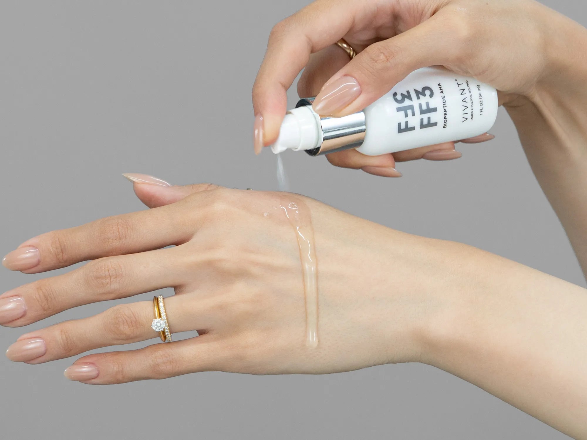 Laziza from LAZ Skincare demonstrating the texture and application of Vivant FF3 BioPeptide AHA on her hand