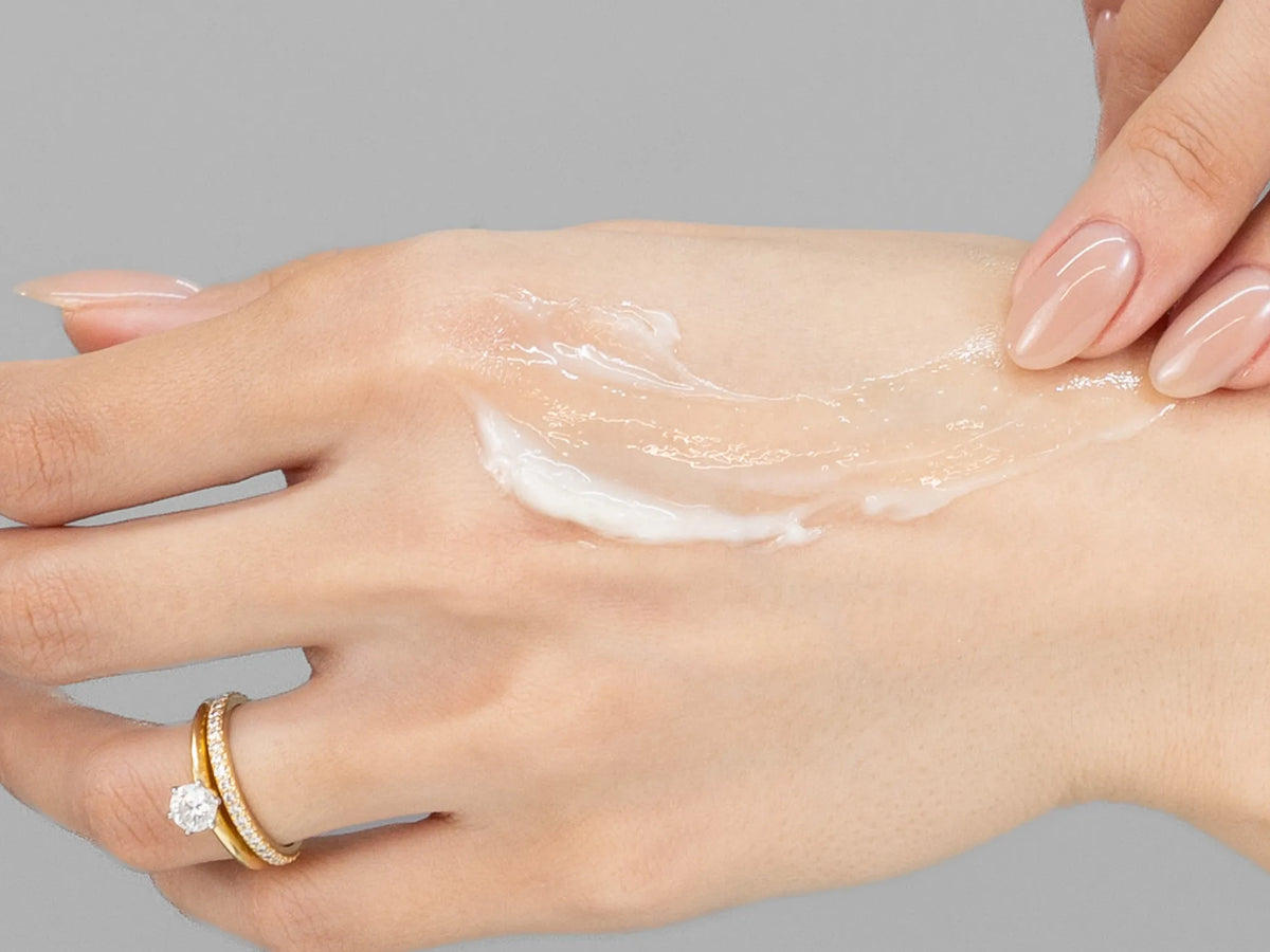 Laziza from LAZ Skincare demonstrating the texture and application of Vivant Recovery Ointment on her hand