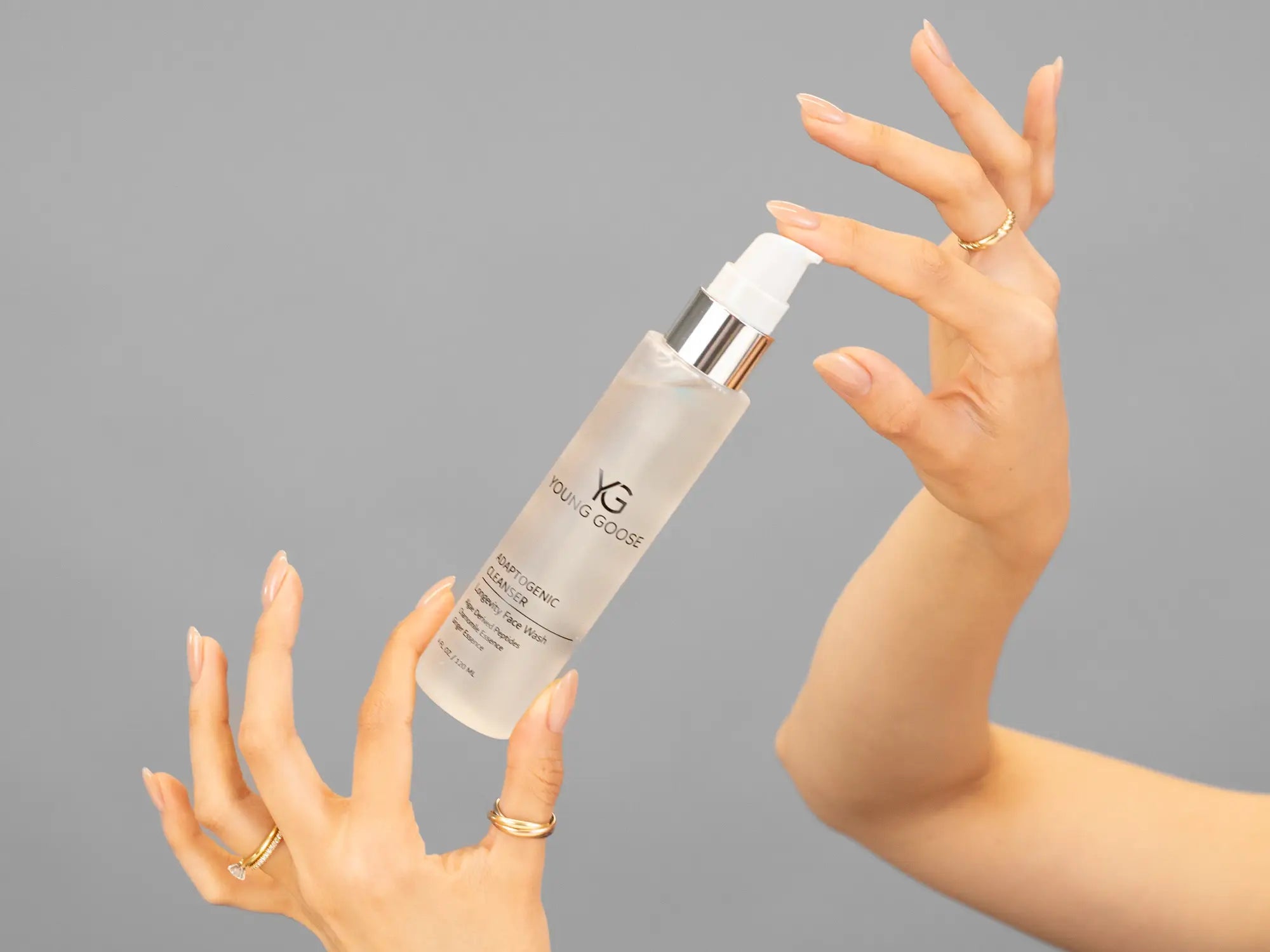 Closeup of Laziza from LAZ Skincare holding up a bottle of Young Goose Adaptogenic Cleanser