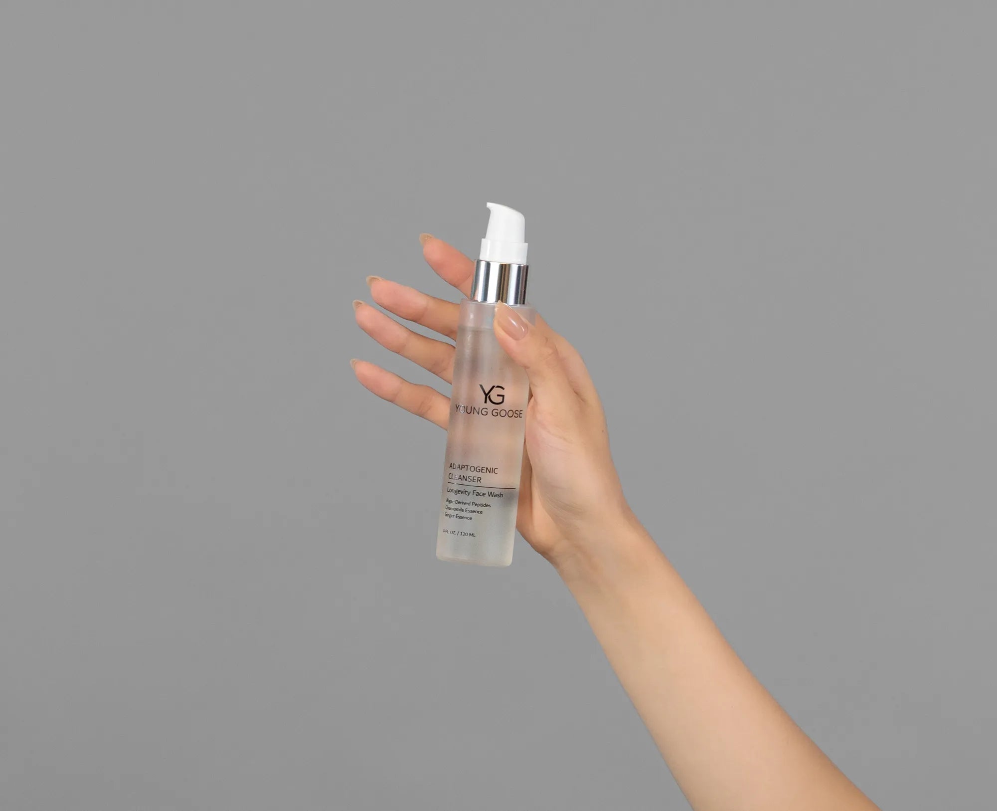 Closeup of Laziza from LAZ Skincare holding up a bottle of Young Goose Adaptogenic Cleanser