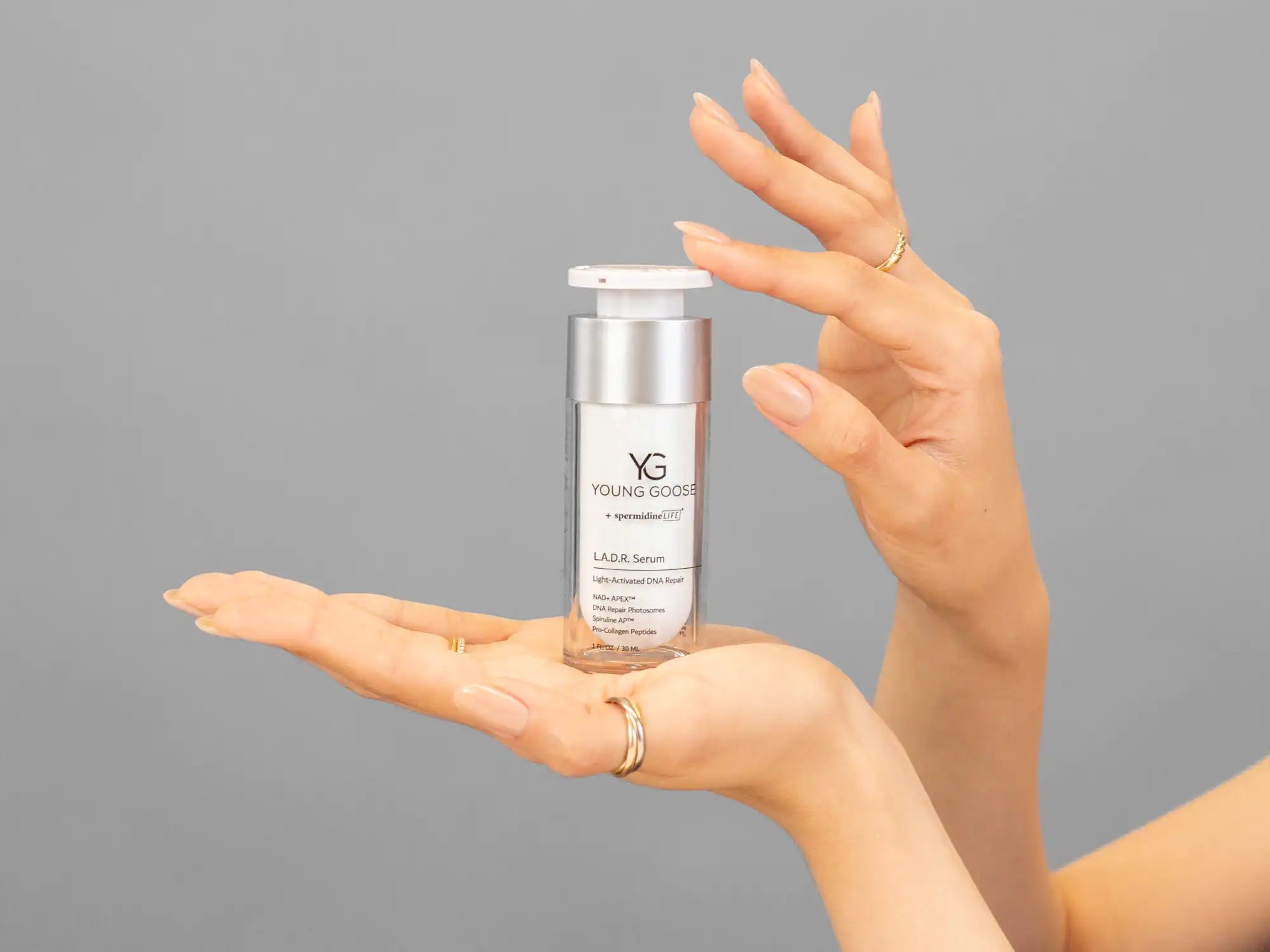 Closeup of Laziza from LAZ Skincare holding up a bottle of Young Goose L.A.D.R. Serum