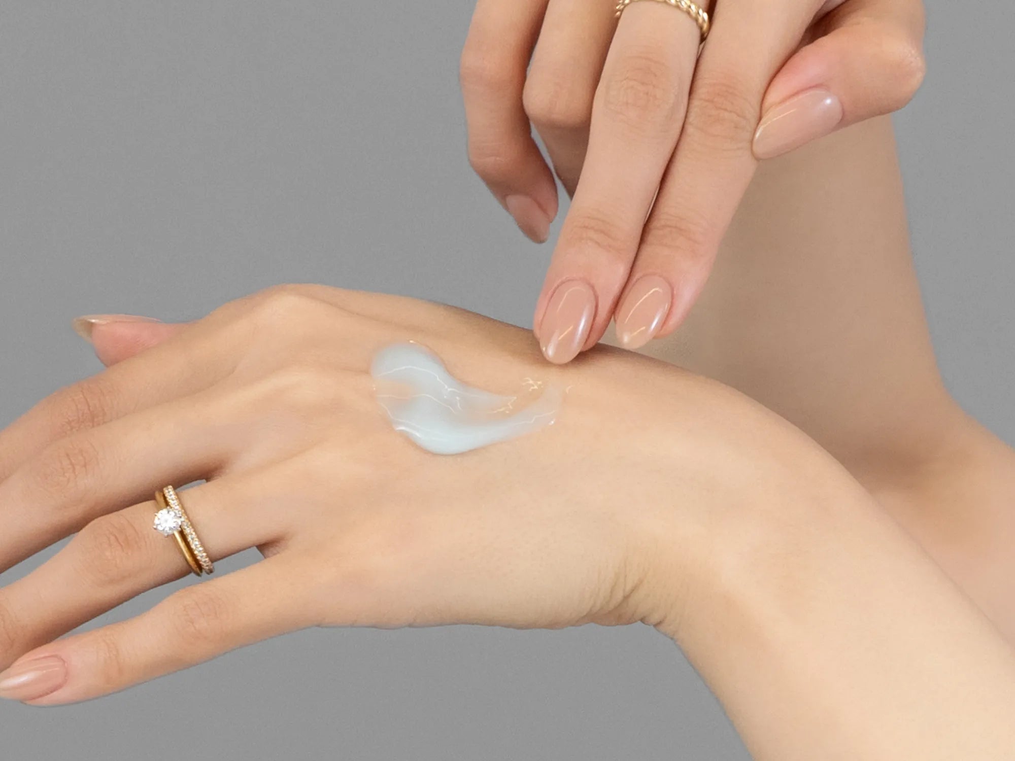 Laziza from LAZ Skincare demonstrating the texture and application of Young Goose L.A.D.R. Serum on her hand