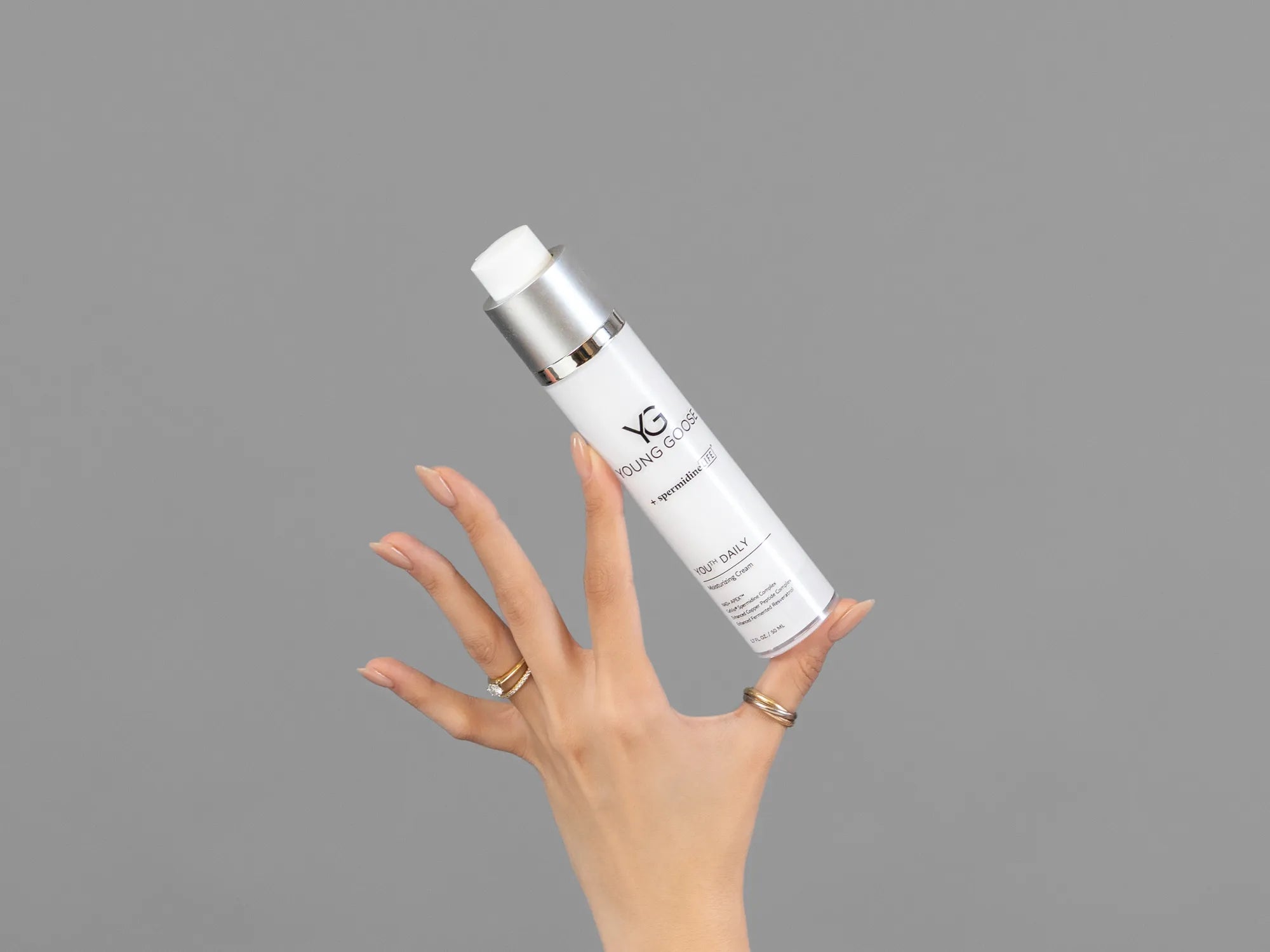 Closeup of Laziza from LAZ Skincare holding up a bottle of Young Goose Youth Daily