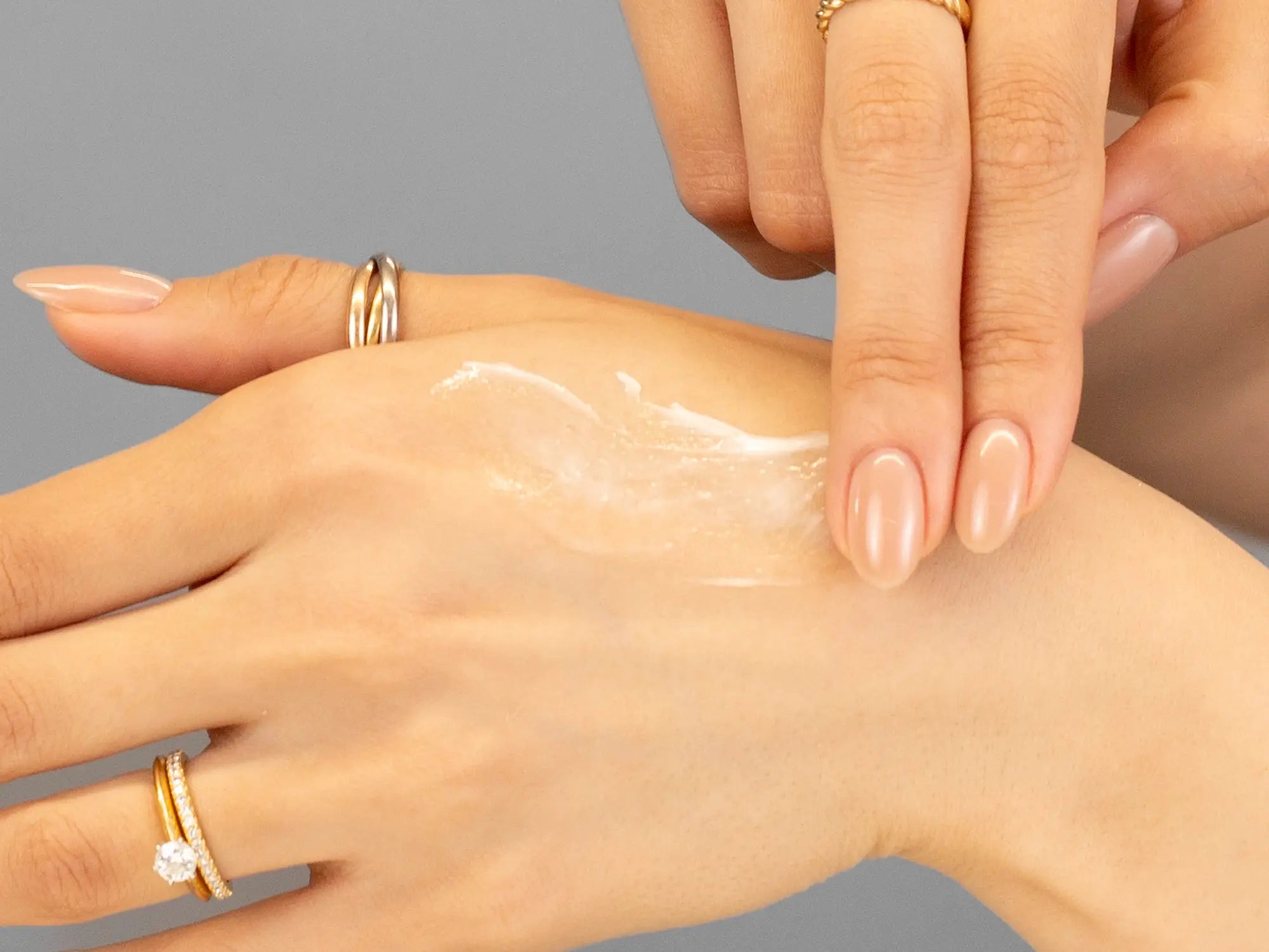 Laziza from LAZ Skincare demonstrating the texture and application of Young Goose Youth Daily on her hand