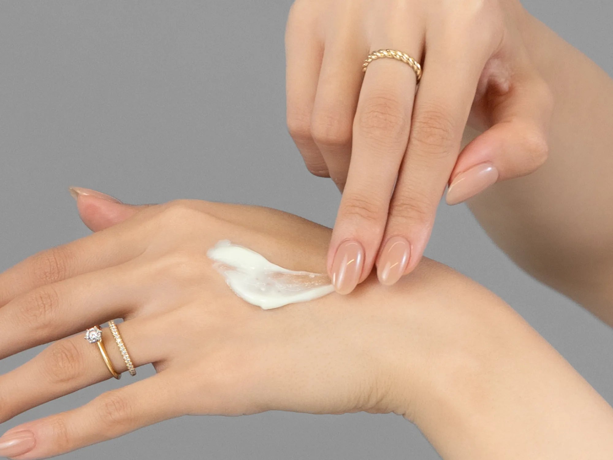 Laziza from LAZ Skincare demonstrating the texture and application of Young Goose Youth Daily on her hand