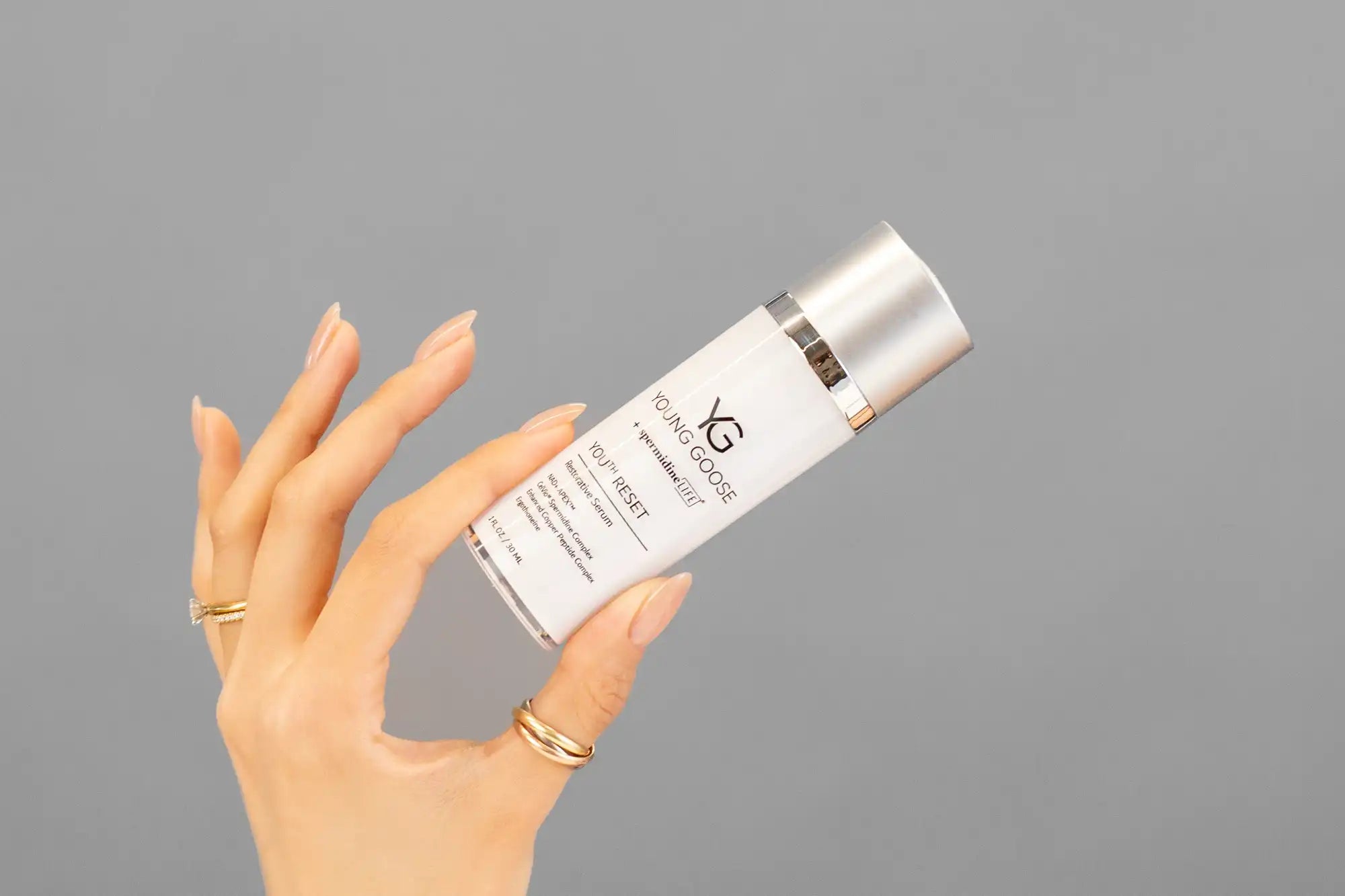 Closeup of Laziza from LAZ Skincare holding up a bottle of Young Goose Youth Reset