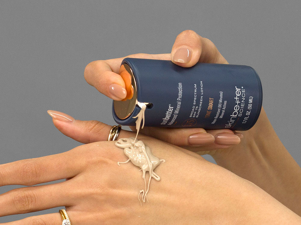 Laziza from LAZ Skincare demonstrating the texture and application of SkinBetter Science sunbetter TONE SMART SPF 75 Sunscreen Lotion on her hand